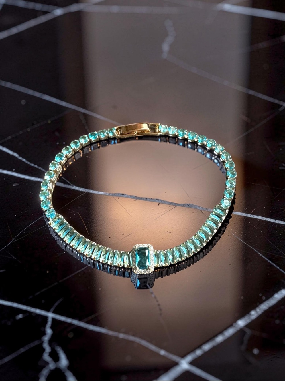 Gold Toned Tennis Bracelet with Blue Crystal